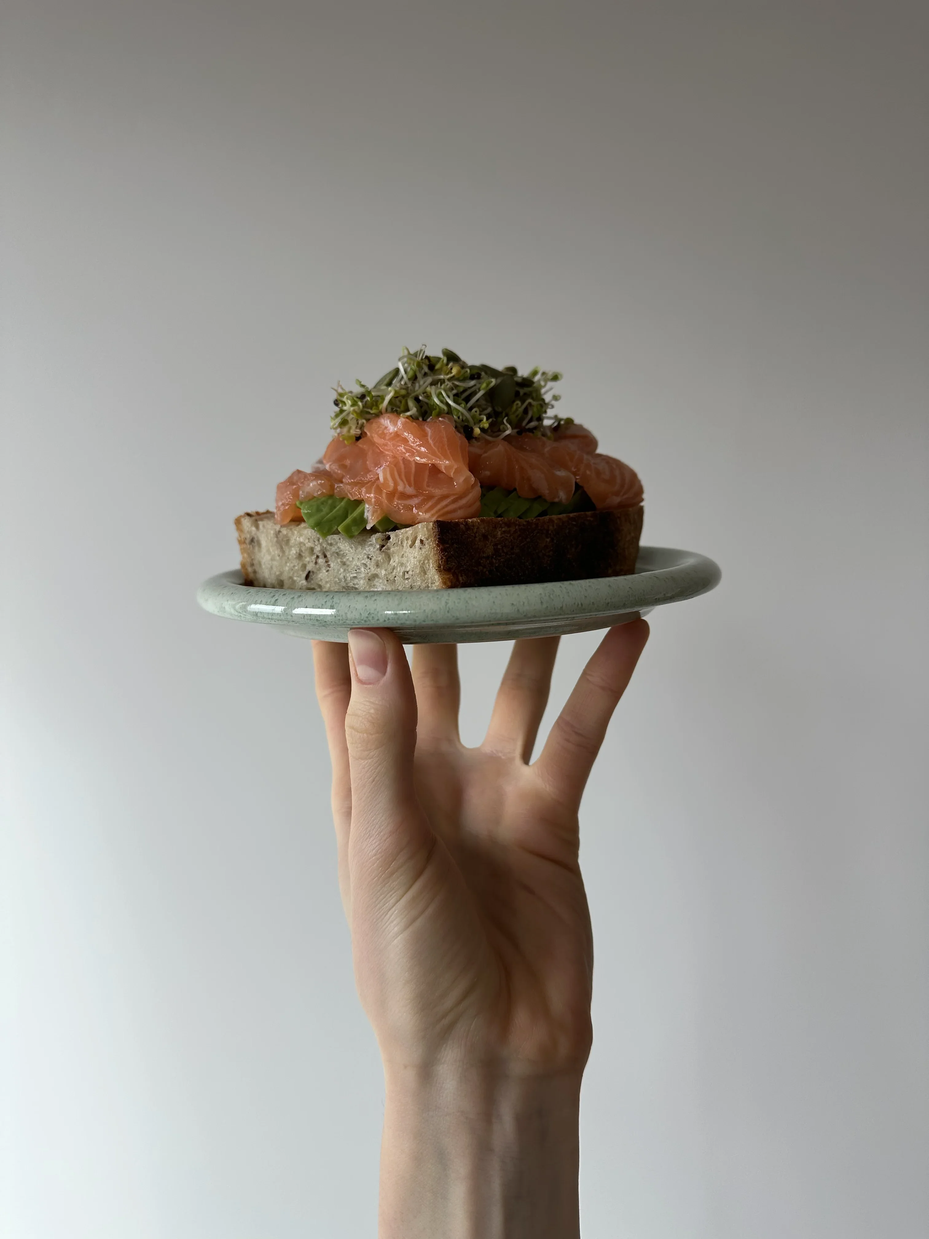 Sourdough bread served with salted fish and fresh microgreens